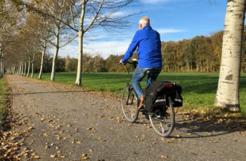 Man riding bike with panniers.